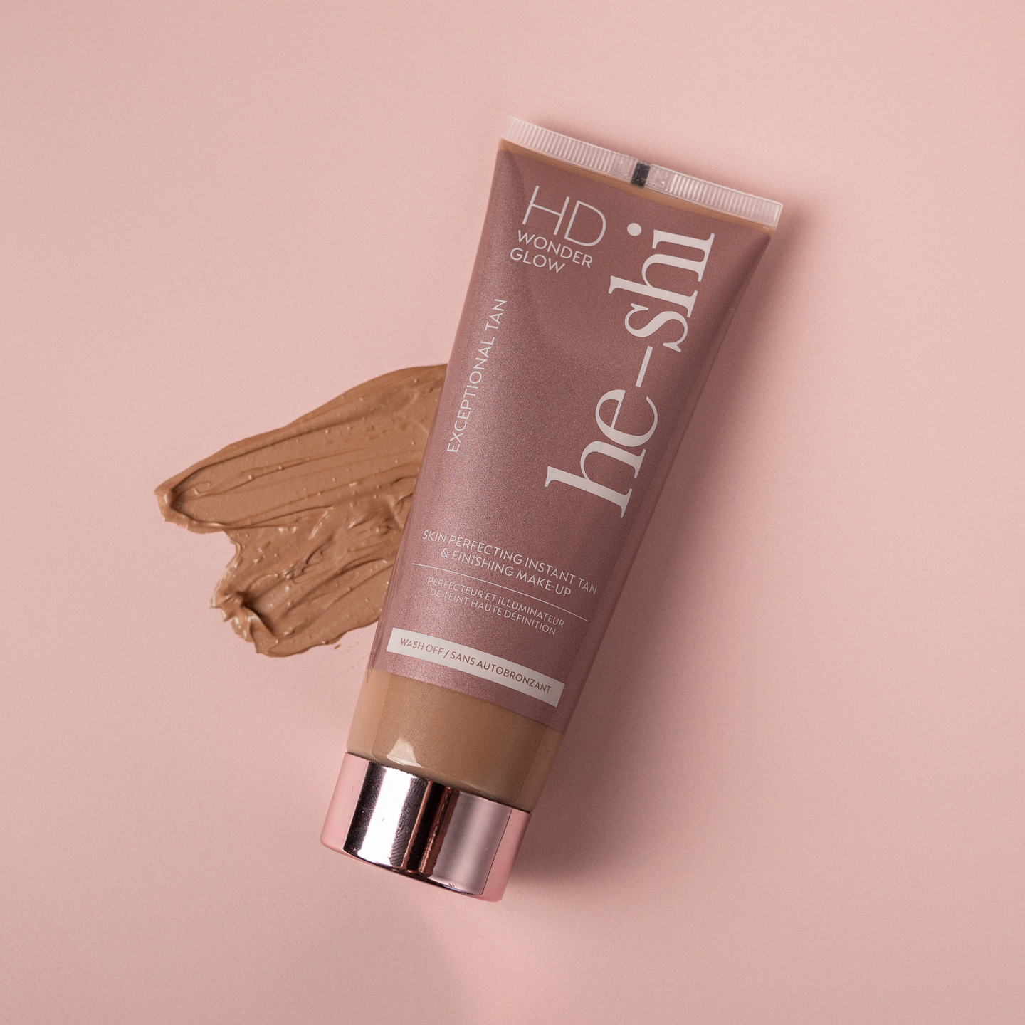 Image of HD Wonder Glow tube lying on its side with a cream texture of the product beside it